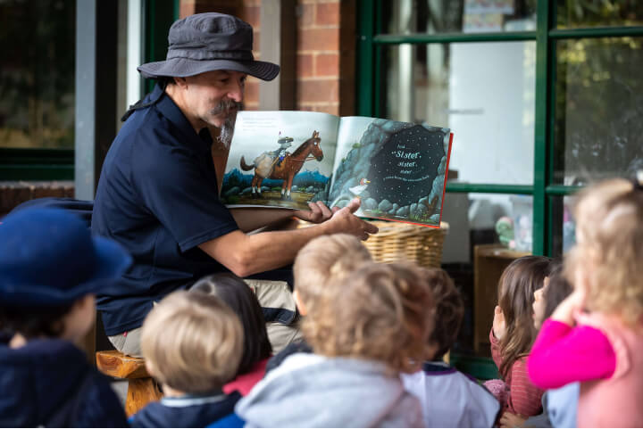 teacher is tell story from story book to kids